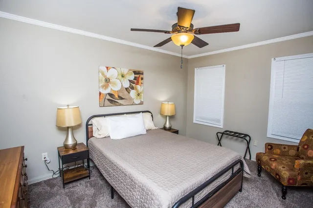 a bedroom with a bed and a chandelier