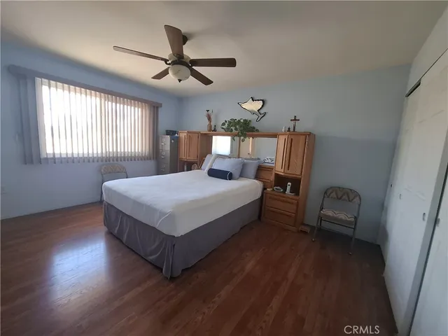 a bedroom with a bed and a night stand