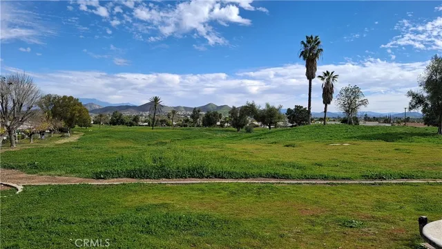 a view of a big yard with a house in the background