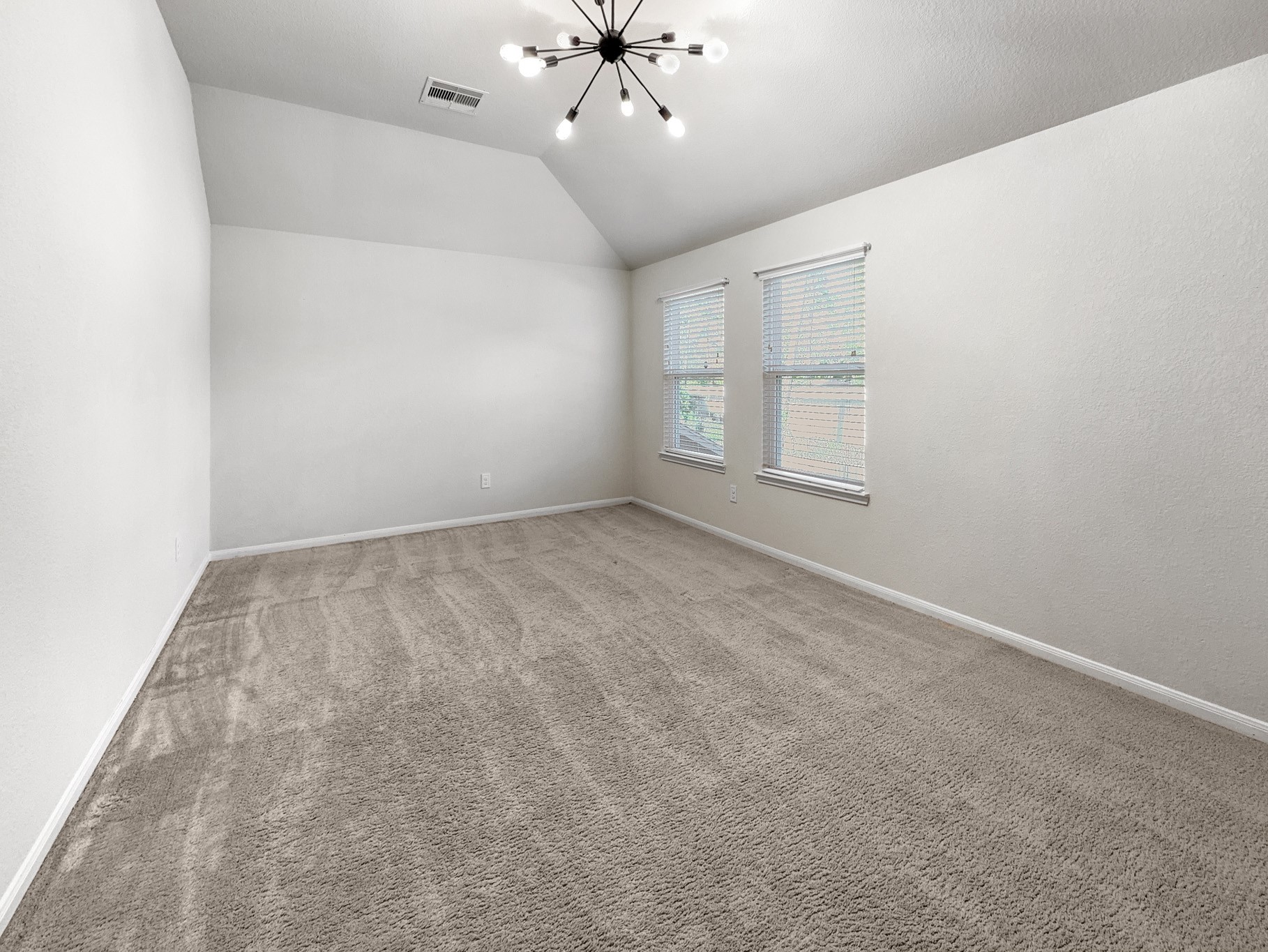 2269 Garden Square Path Spring, TX 77386 - Photo 17 of 18 an empty room with chandelier fan and windows
