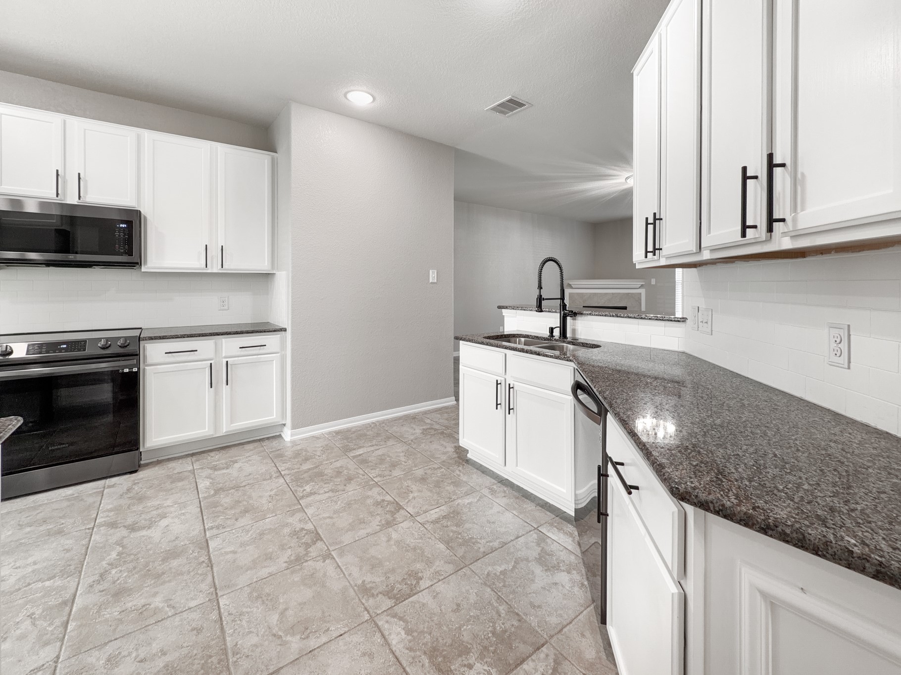 2269 Garden Square Path Spring, TX 77386 - Photo 2 of 18 a kitchen with stainless steel appliances granite countertop a sink stove and cabinets