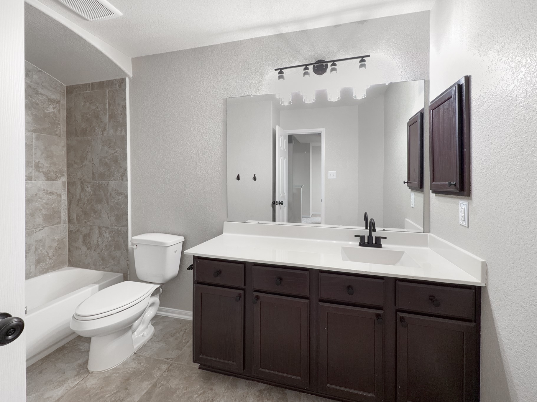 2269 Garden Square Path Spring, TX 77386 - Photo 6 of 18 a bathroom with a toilet a sink a mirror and vanity