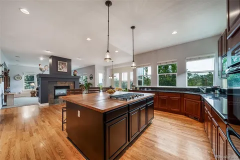 a kitchen with stainless steel appliances refrigerator microwave dining table and chairs