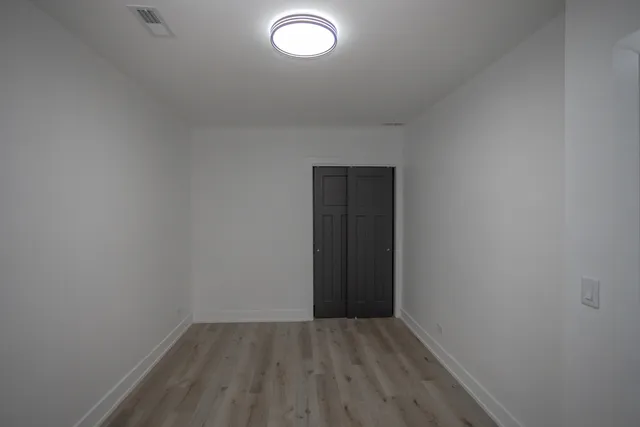 a view of an empty room and wooden floor