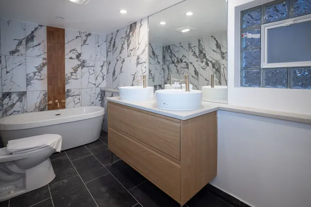 a bathroom with a sink toilet and shower