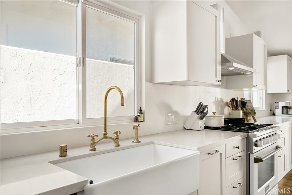 448 Princeton Drive Costa Mesa, CA 92626 - Photo 11 of 33 a kitchen with sink a window and cabinets