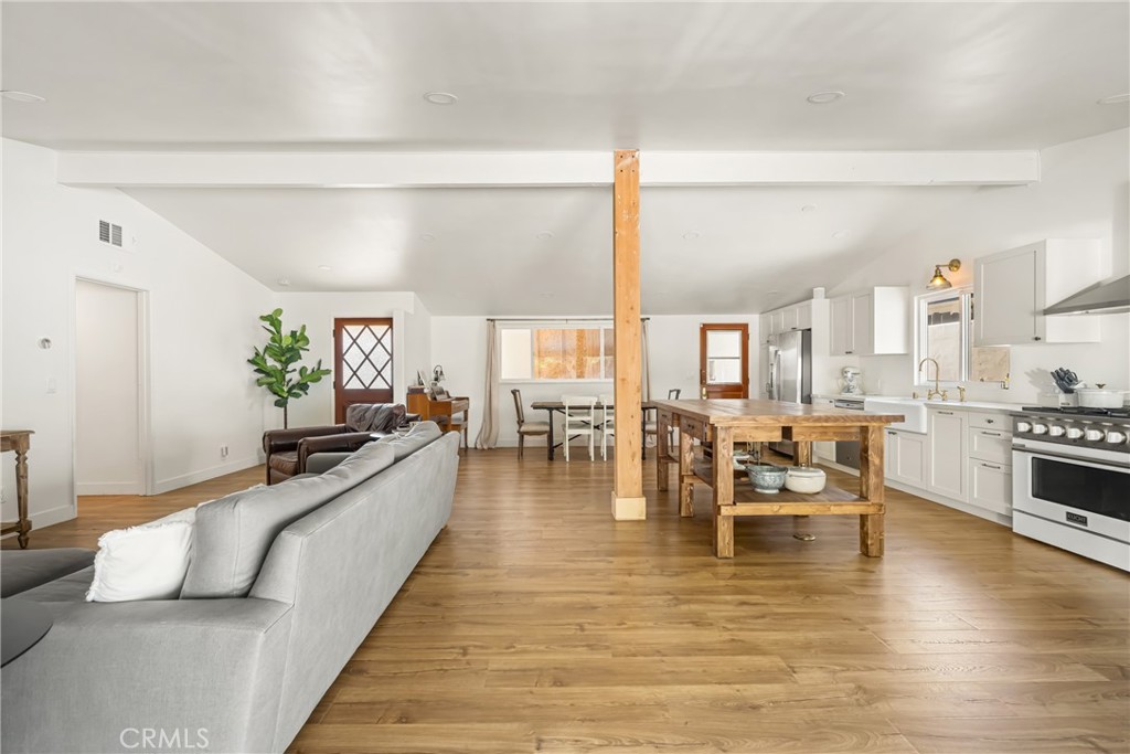 448 Princeton Drive Costa Mesa, CA 92626 - Photo 12 of 33 a living room with furniture wooden floor and a large window