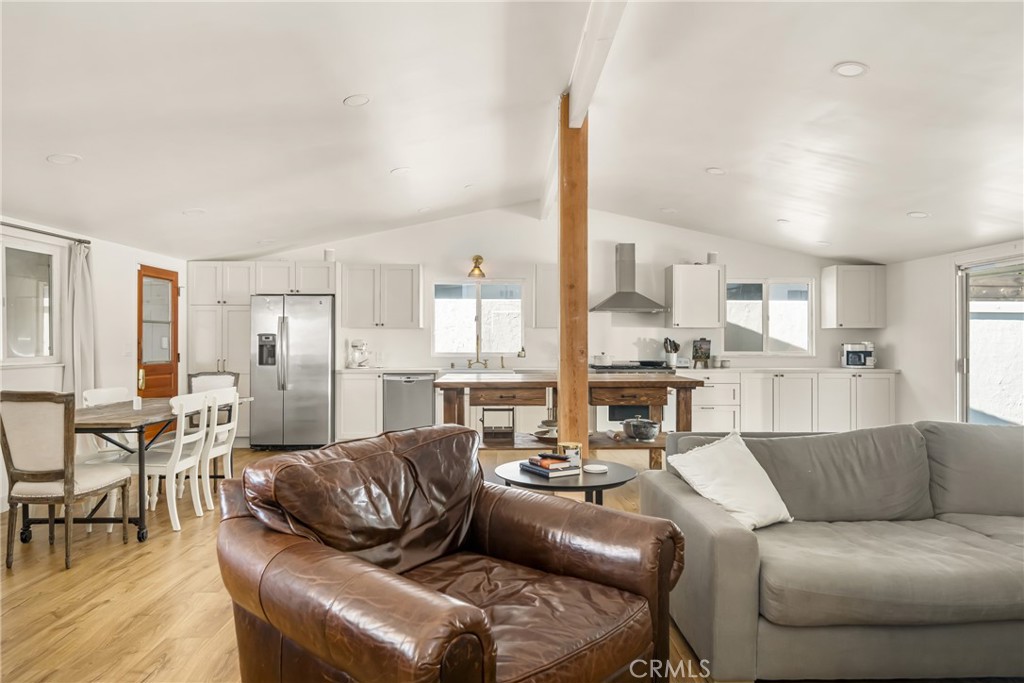 448 Princeton Drive Costa Mesa, CA 92626 - Photo 13 of 33 a living room with furniture kitchen view and a wooden floor