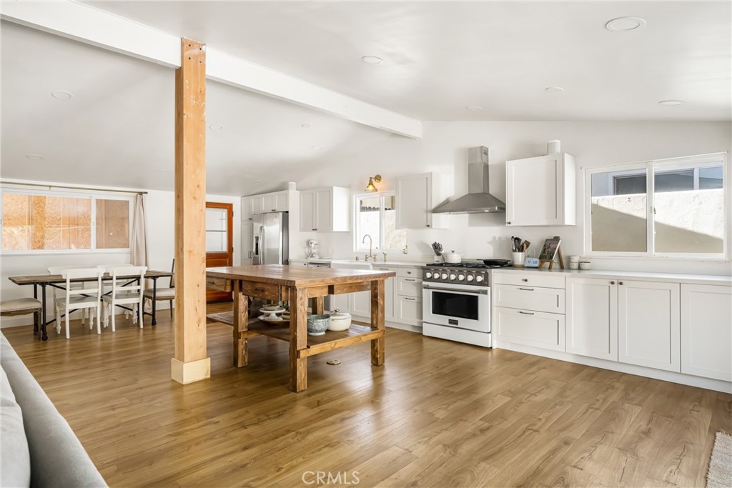 448 Princeton Drive Costa Mesa, CA 92626 - Photo 7 of 33 a kitchen with a stove and white cabinets