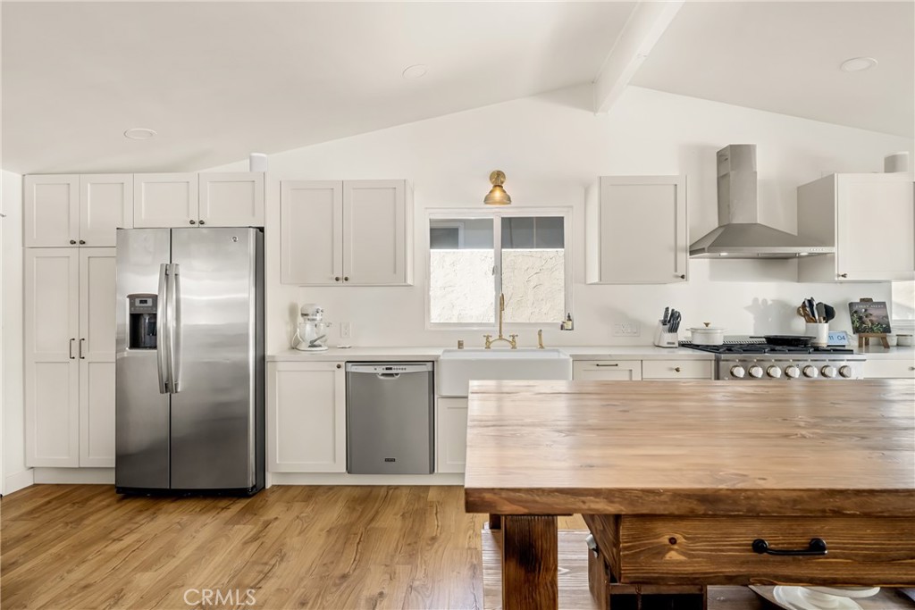 448 Princeton Drive Costa Mesa, CA 92626 - Photo 8 of 33 a kitchen with stainless steel appliances granite countertop a refrigerator a stove and a sink