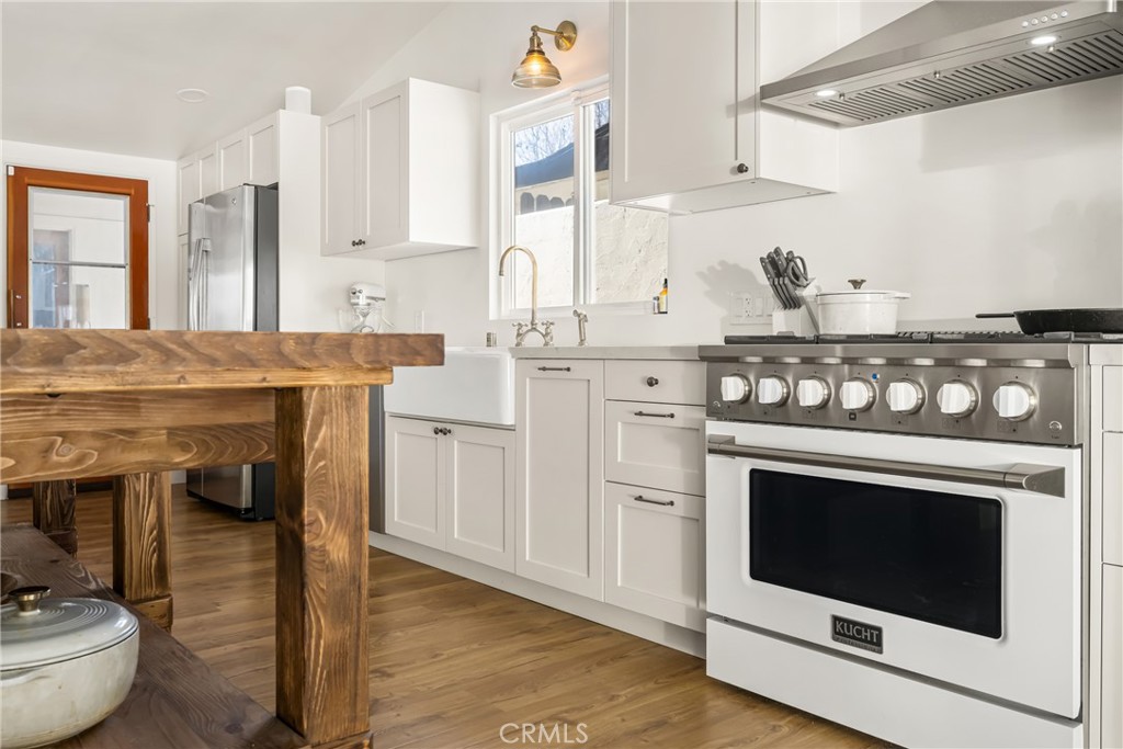 448 Princeton Drive Costa Mesa, CA 92626 - Photo 10 of 33 a kitchen with stainless steel appliances granite countertop a stove and a sink