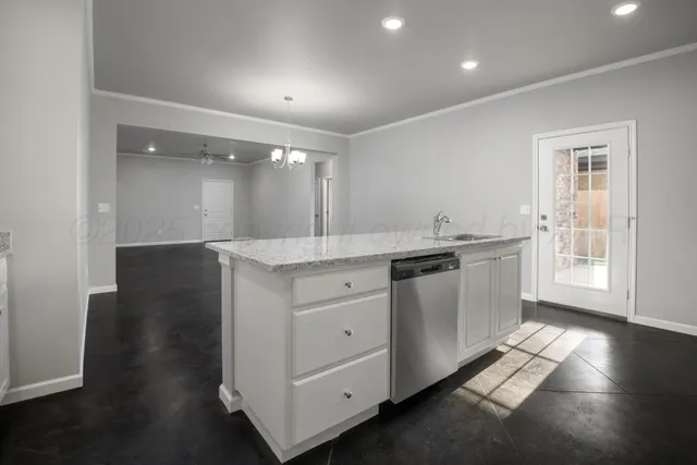 a large white kitchen with a sink
