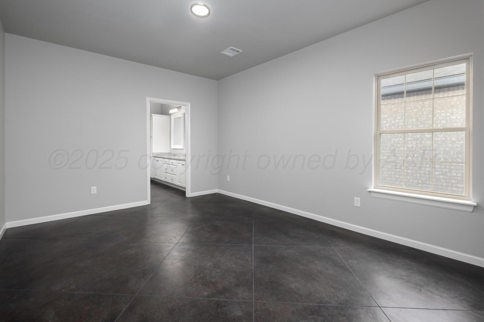 4600 Richardson Road Amarillo, TX 79118 - Photo 15 of 29 an empty room with wooden floor and windows