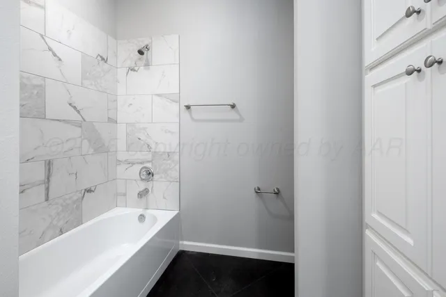 a bathroom with a bathtub and shower