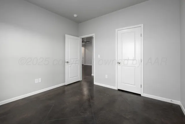 an empty room with closet area