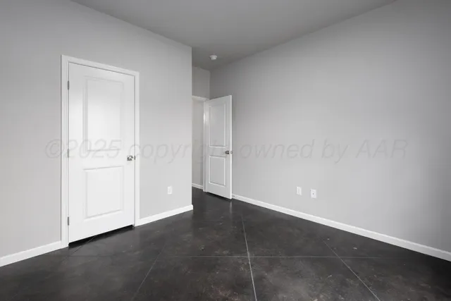 an empty room with closet area