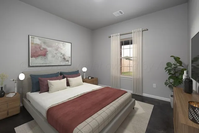 a bedroom with bed and a potted plant