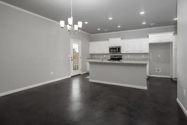 a kitchen with kitchen island stainless steel appliances a sink stove and cabinets