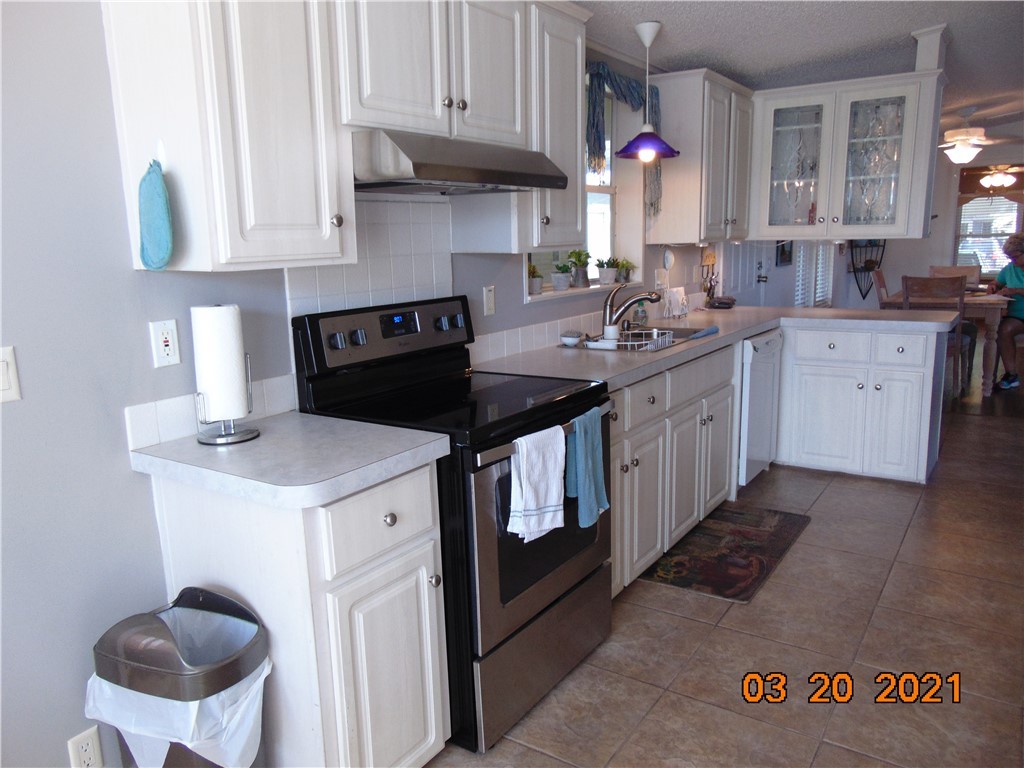 7615 Montauk Avenue, Unit R9 Micco, FL 32976 - Photo 12 of 36 a kitchen with a sink stove and cabinets