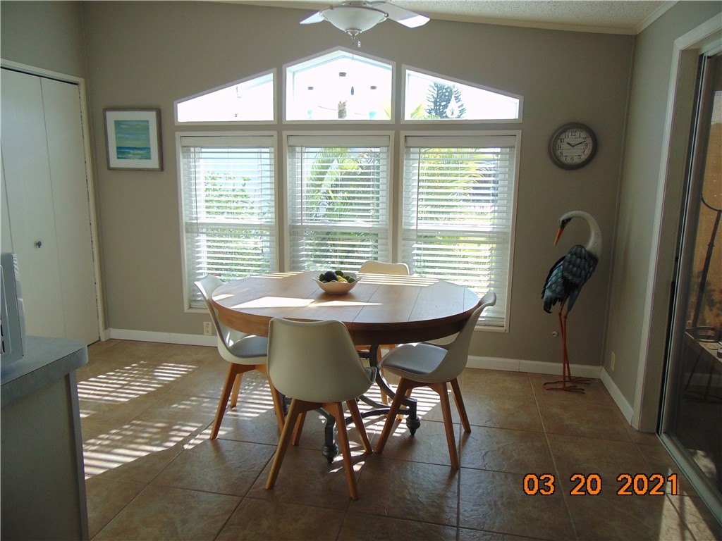 7615 Montauk Avenue, Unit R9 Micco, FL 32976 - Photo 14 of 36 a view of a dining room with furniture and windows