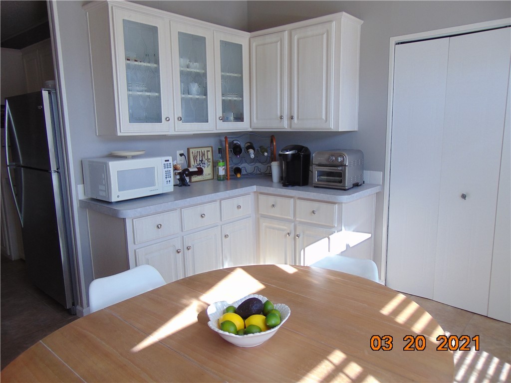 7615 Montauk Avenue, Unit R9 Micco, FL 32976 - Photo 15 of 36 a kitchen with cabinets and appliances