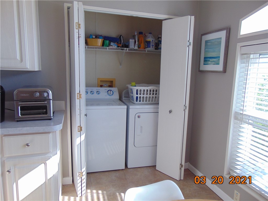 7615 Montauk Avenue, Unit R9 Micco, FL 32976 - Photo 16 of 36 a kitchen with a refrigerator and a window