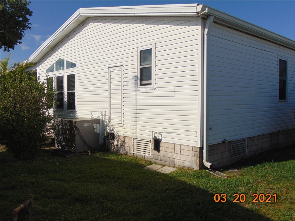 7615 Montauk Avenue, Unit R9 Micco, FL 32976 - Photo 2 of 36 a front view of a house with a garden
