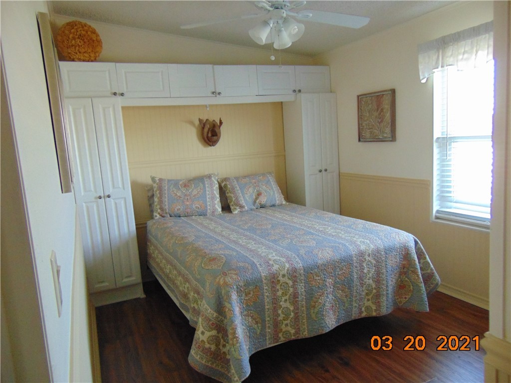 7615 Montauk Avenue, Unit R9 Micco, FL 32976 - Photo 22 of 36 a bedroom with a bed and wooden floor