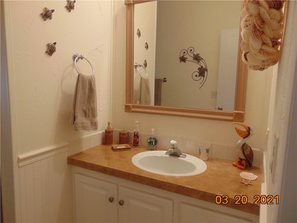 7615 Montauk Avenue, Unit R9 Micco, FL 32976 - Photo 23 of 36 a bathroom with a sink and a mirror