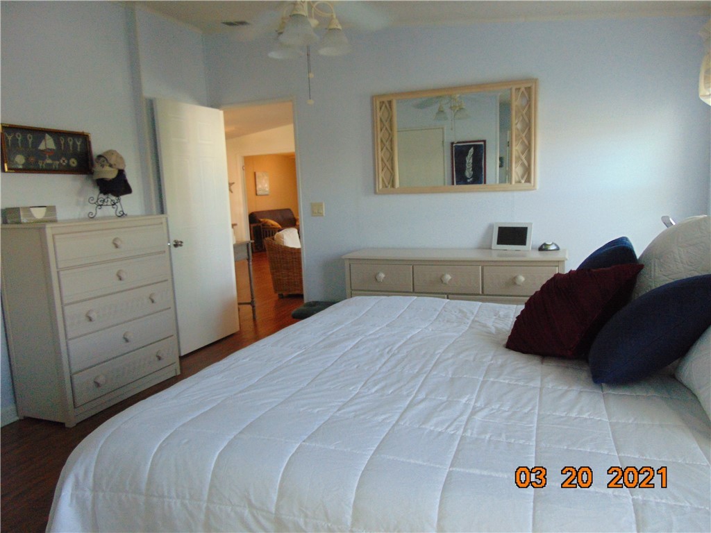 7615 Montauk Avenue, Unit R9 Micco, FL 32976 - Photo 25 of 36 a bedroom with a bed and a cabinets