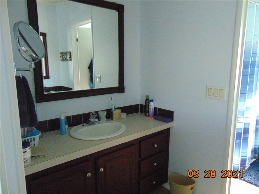 7615 Montauk Avenue, Unit R9 Micco, FL 32976 - Photo 27 of 36 a bathroom with a sink vanity and mirror