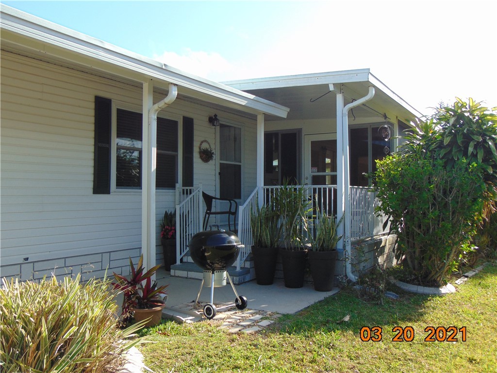 7615 Montauk Avenue, Unit R9 Micco, FL 32976 - Photo 3 of 36 a front view of a house with garden