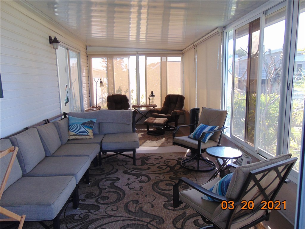 7615 Montauk Avenue, Unit R9 Micco, FL 32976 - Photo 7 of 36 a living room with furniture and floor to ceiling windows