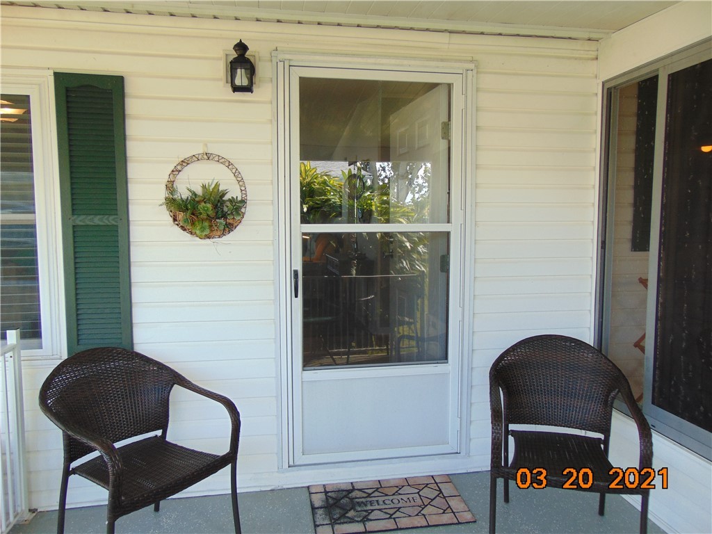 7615 Montauk Avenue, Unit R9 Micco, FL 32976 - Photo 8 of 36 a front view of a house with entryway and wooden floor