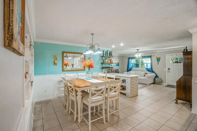 a view of a dining room with furniture and chandelier