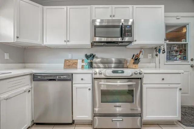a kitchen with stainless steel appliances granite countertop a stove a microwave and cabinets