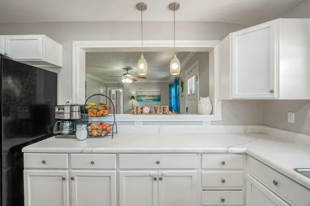 a kitchen with sink and cabinets