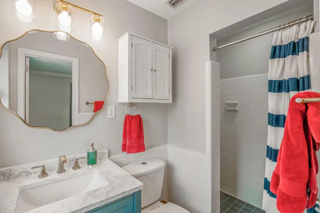 a bathroom with a sink vanity and toilet