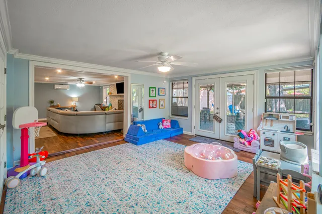 a living room with furniture and a floor to ceiling window