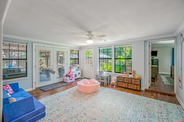 a living room with furniture and a floor to ceiling window