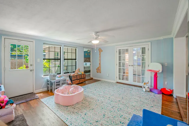 a living room with furniture and a wooden floor