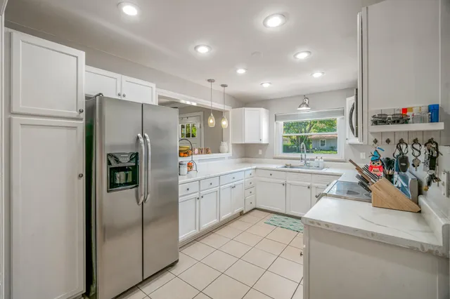 a kitchen with a refrigerator and a sink