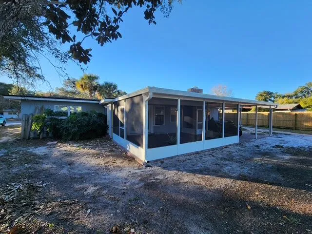 a view of a porch with a table and chairs