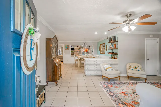 a living room with furniture a rug and decor