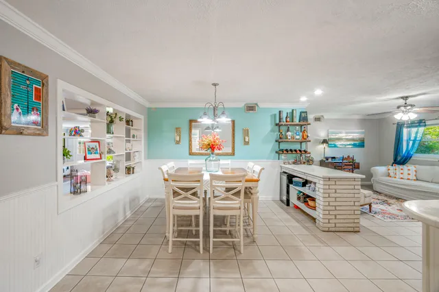 a kitchen with stainless steel appliances a table and chairs in it