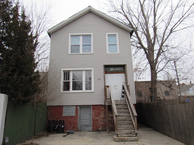 1752 West Cullerton Street Chicago, IL 60608 - Photo 1 of 31 a front view of a house with stairs