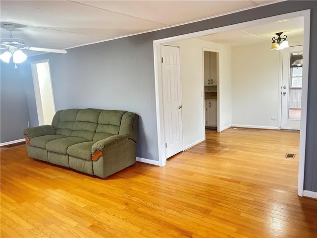 a living room with hard wood floors and a couch