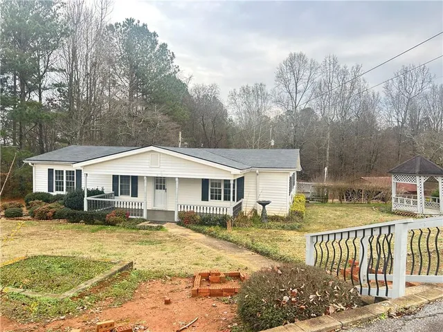 a view of a house with a yard covered in snow
