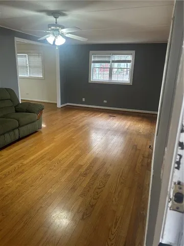 a view of livingroom with hardwood floor and ceiling fan