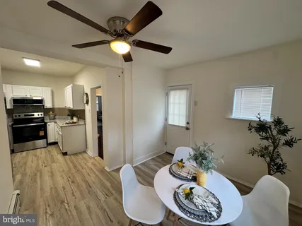 a kitchen with stainless steel appliances kitchen island granite countertop wooden floor
